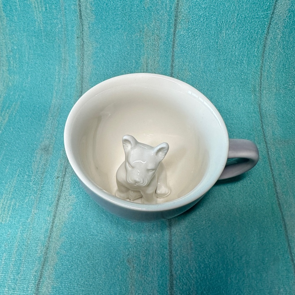 creature cups dog inside mug